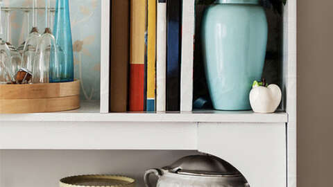 Shelf with teal vase and decorative items