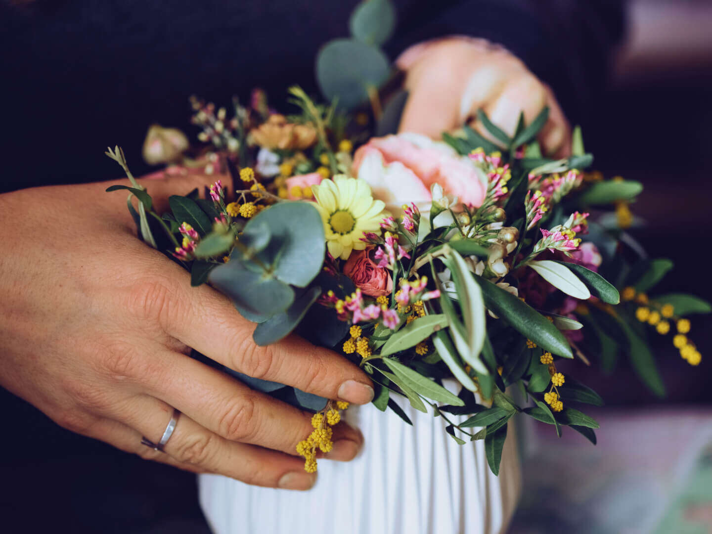Hands holding beautiful flower arrangement